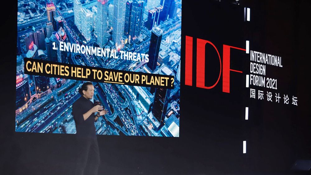 Georges Hung speaking at International Design Forum 2021 in front of a slide asking ‘Can cities help to save our planet?’