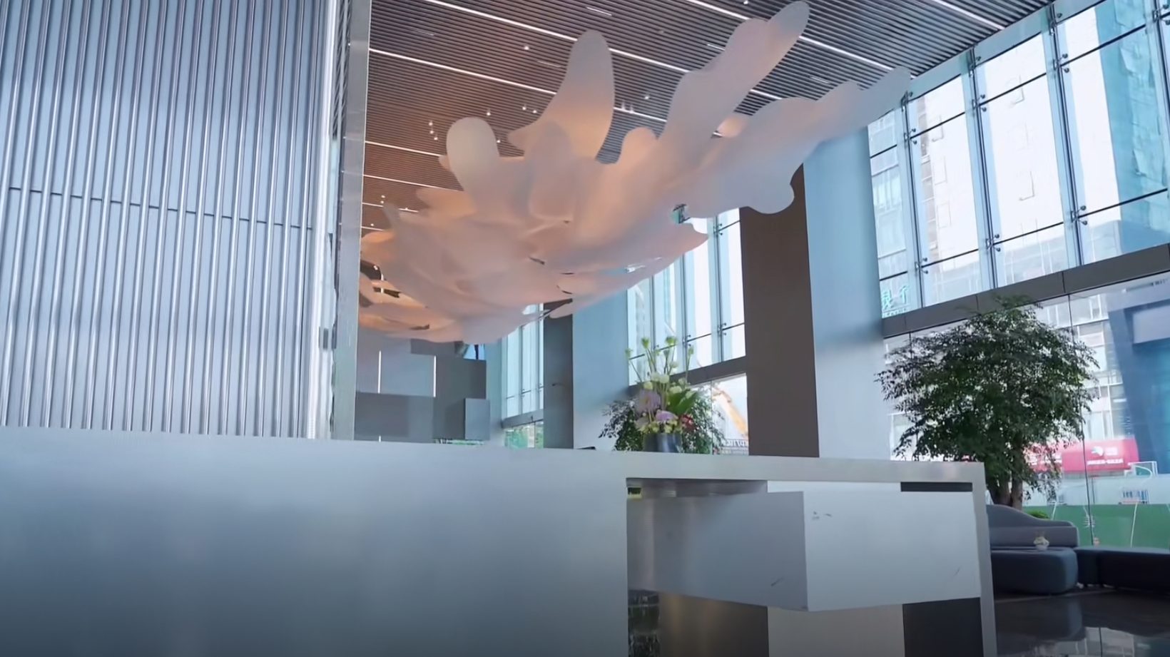 Photograph of the reception desk beneath the cloud, glazing to the street