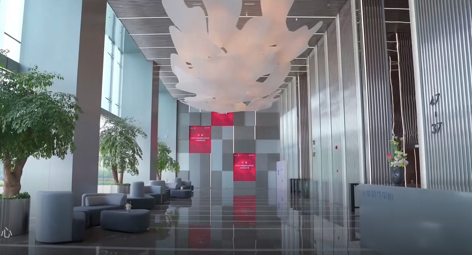 The lobby seen from the entrance, the cloud above and a red feature wall beyond