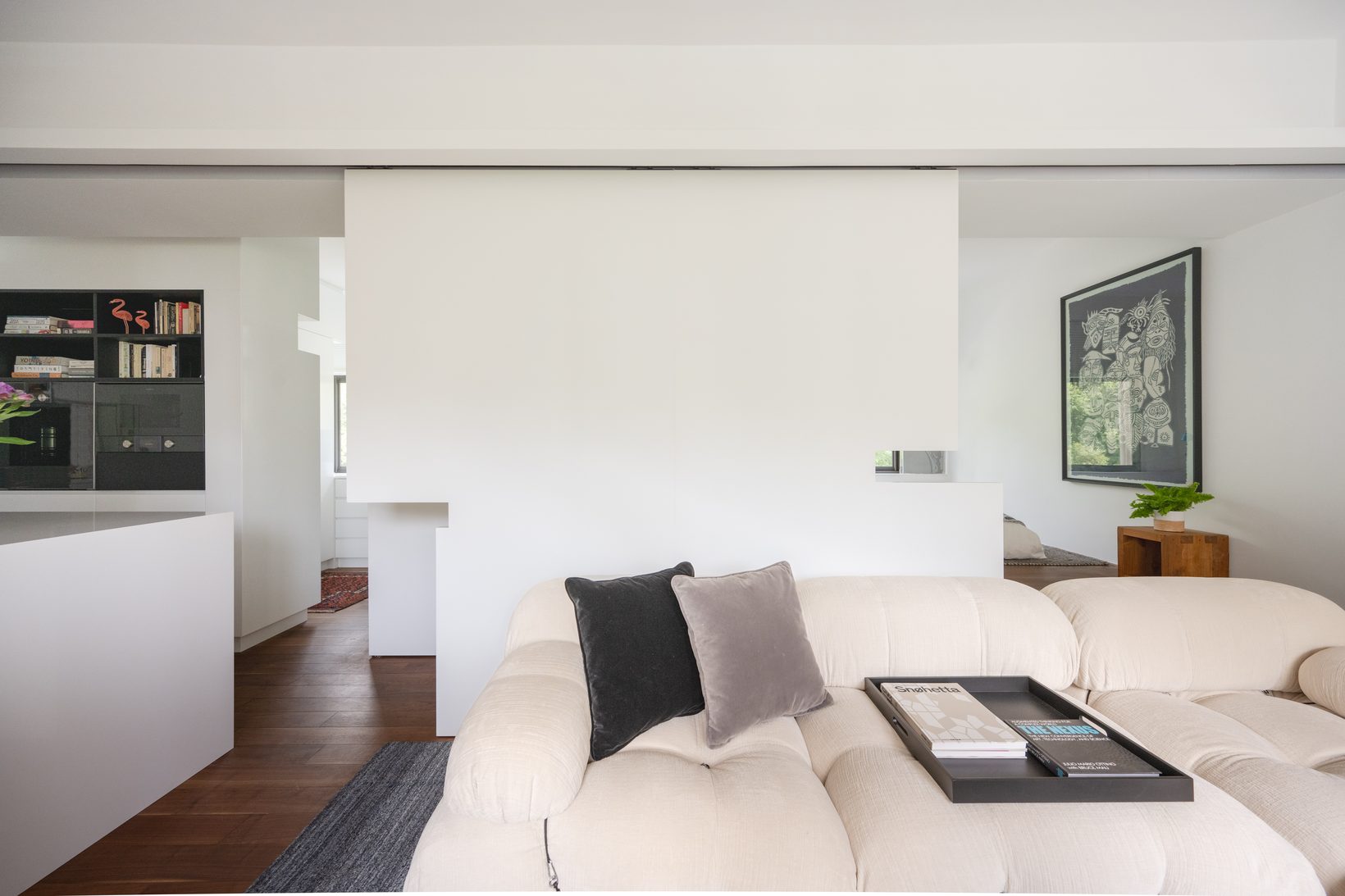 The sliding panel partly open, the bedroom beginning to show