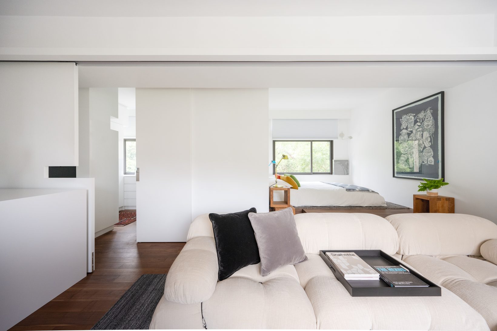 The sliding panel pushed back, the bed visible by the window