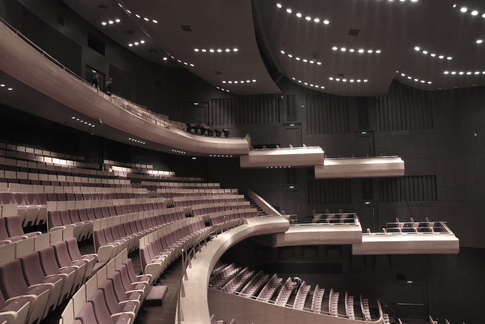 Curved balcony fronts stepping down toward the stage