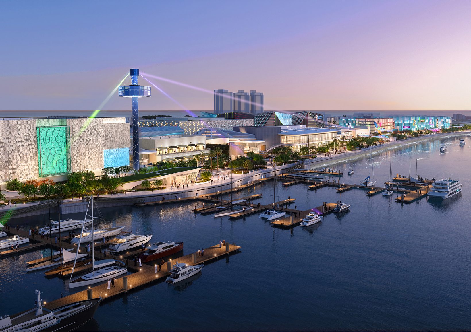 The marina at dusk with moored boats, the complex and its tower beyond
