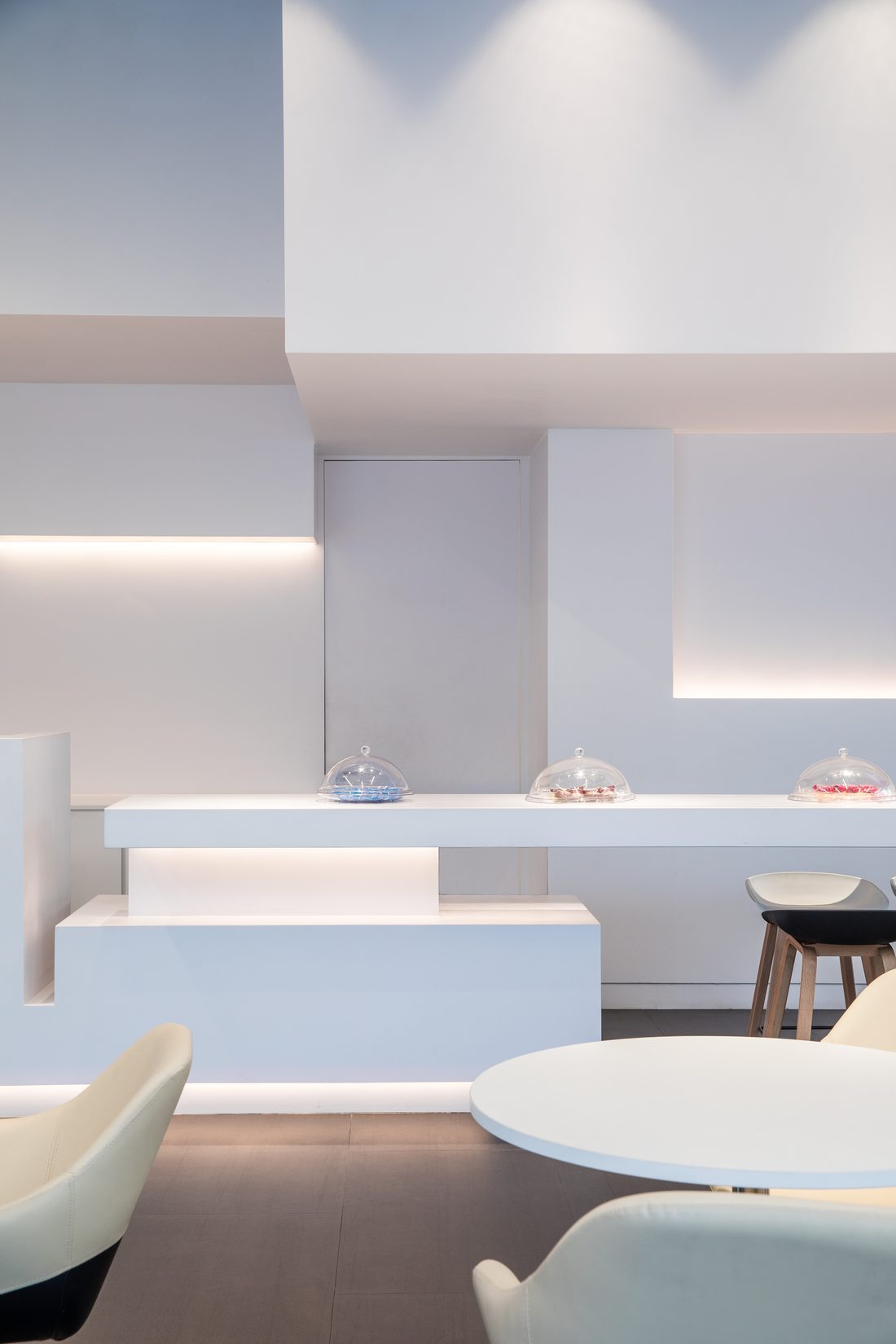 The stepped wall rising above a café table, light washing down its recesses