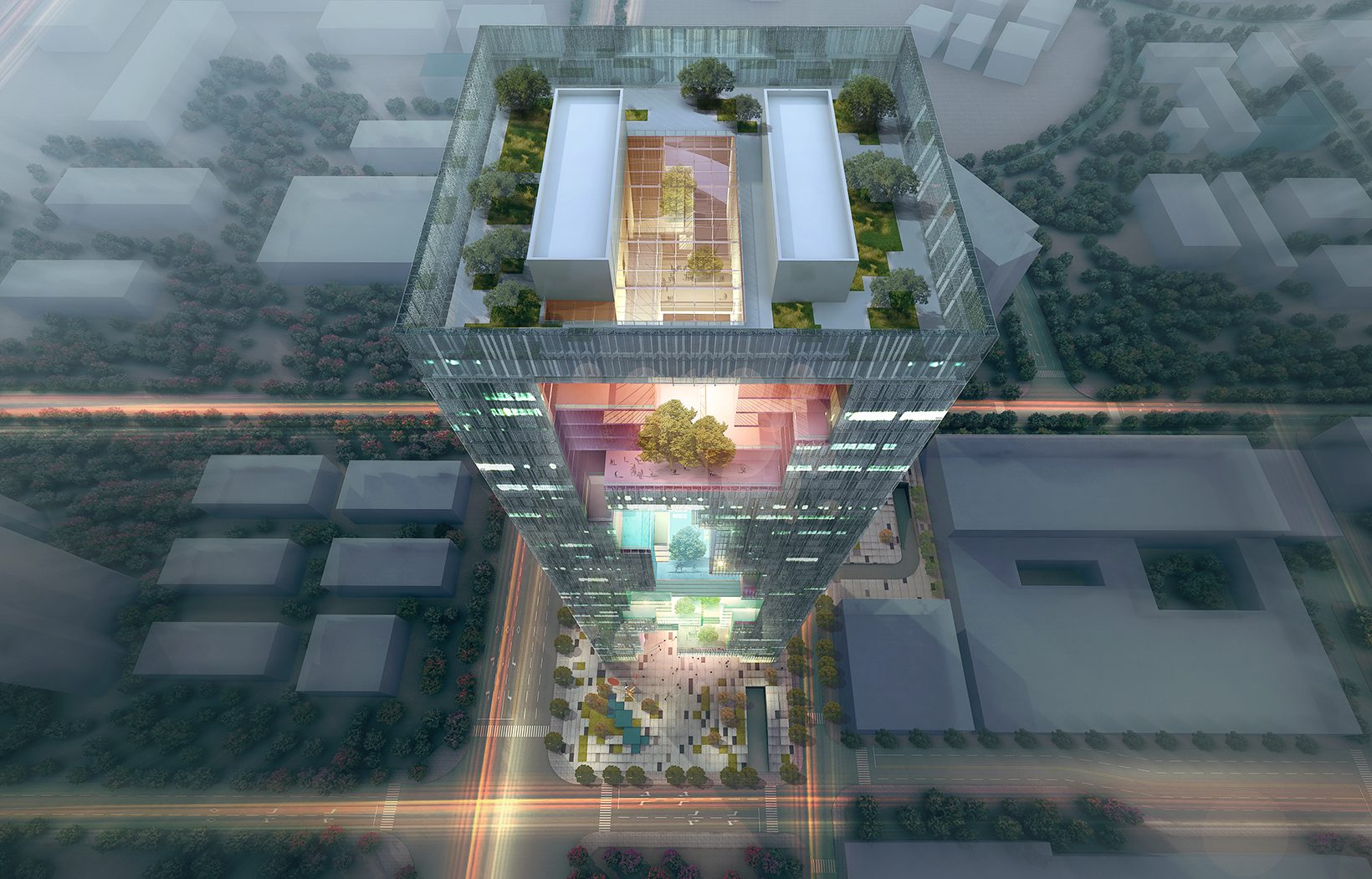 Bird’s-eye view at dusk: the lit void and roof gardens of the tower above the industrial park