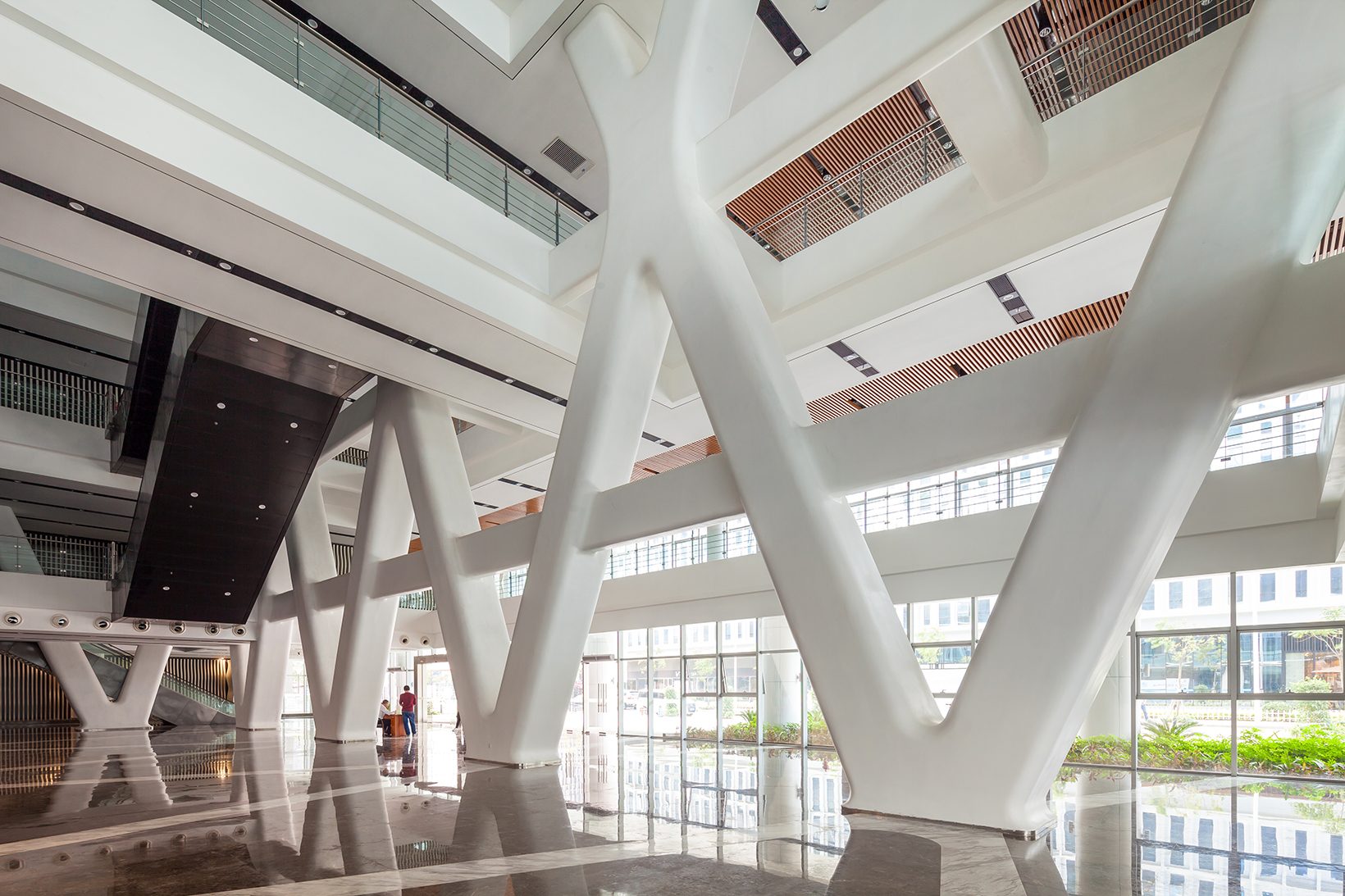 The lobby interior with white diagonal columns and a dark timber ceiling