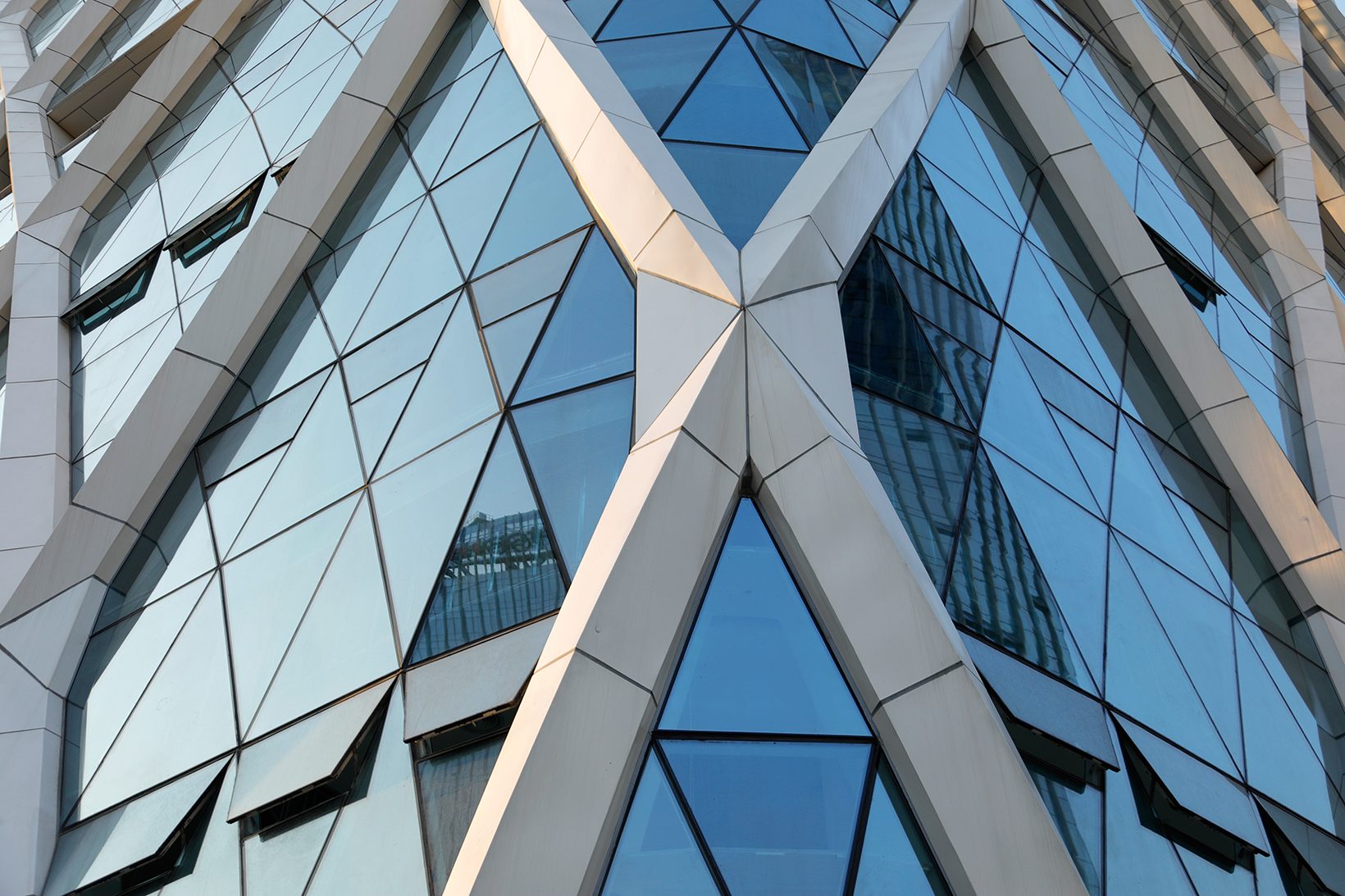 Close view of the diagonal members meeting at a node above glazing
